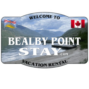A picture of the beach with a sign that says welcome to bealby point stay.